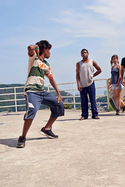 Dancing in the streets. a group of young people watching a breakdancer in the streets