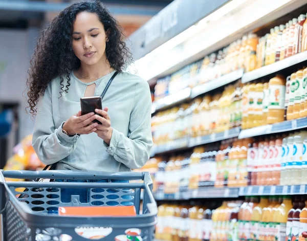 Supermarket, phone and woman shopping, search and on internet for grocery store product, drink or juice. Customer on 5g technology fintech app for buying healthy or wellness food in inflation economy.
