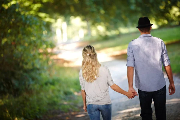 あなたが恋をしているときに人生は完璧です 公園で手をつないで歩いている若いカップルのレビューショット — ストック写真