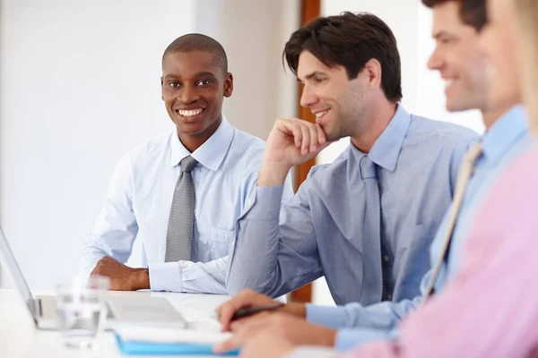 Having a productive meeting. Portrait of a handsome businessman sitting with his colleagues in a meeting