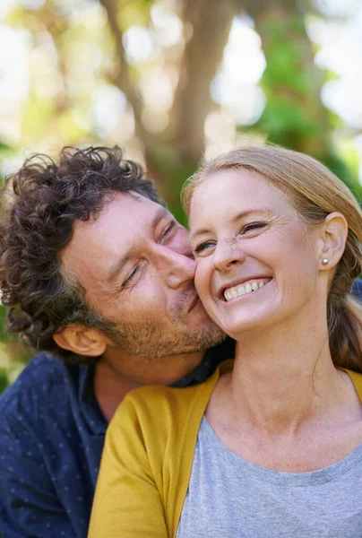 頬に大きなキスをする 屋外に立つ愛する夫と妻 — ストック写真
