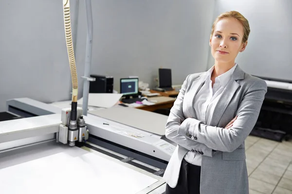 If its printable, we can do it. A self-assured young publisher standing alongside a printing machine