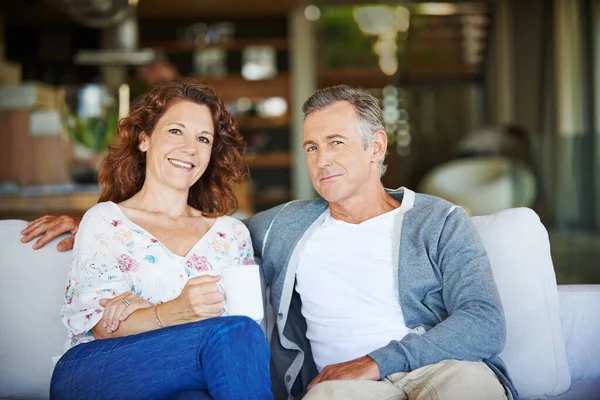 一起喝点咖啡吧 一对快乐而成熟的夫妇在家里的沙发上一起喝咖啡 — 图库照片