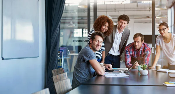 Teamwork with a smile. Portrait of a group of office workers in a meeting in a boardroom