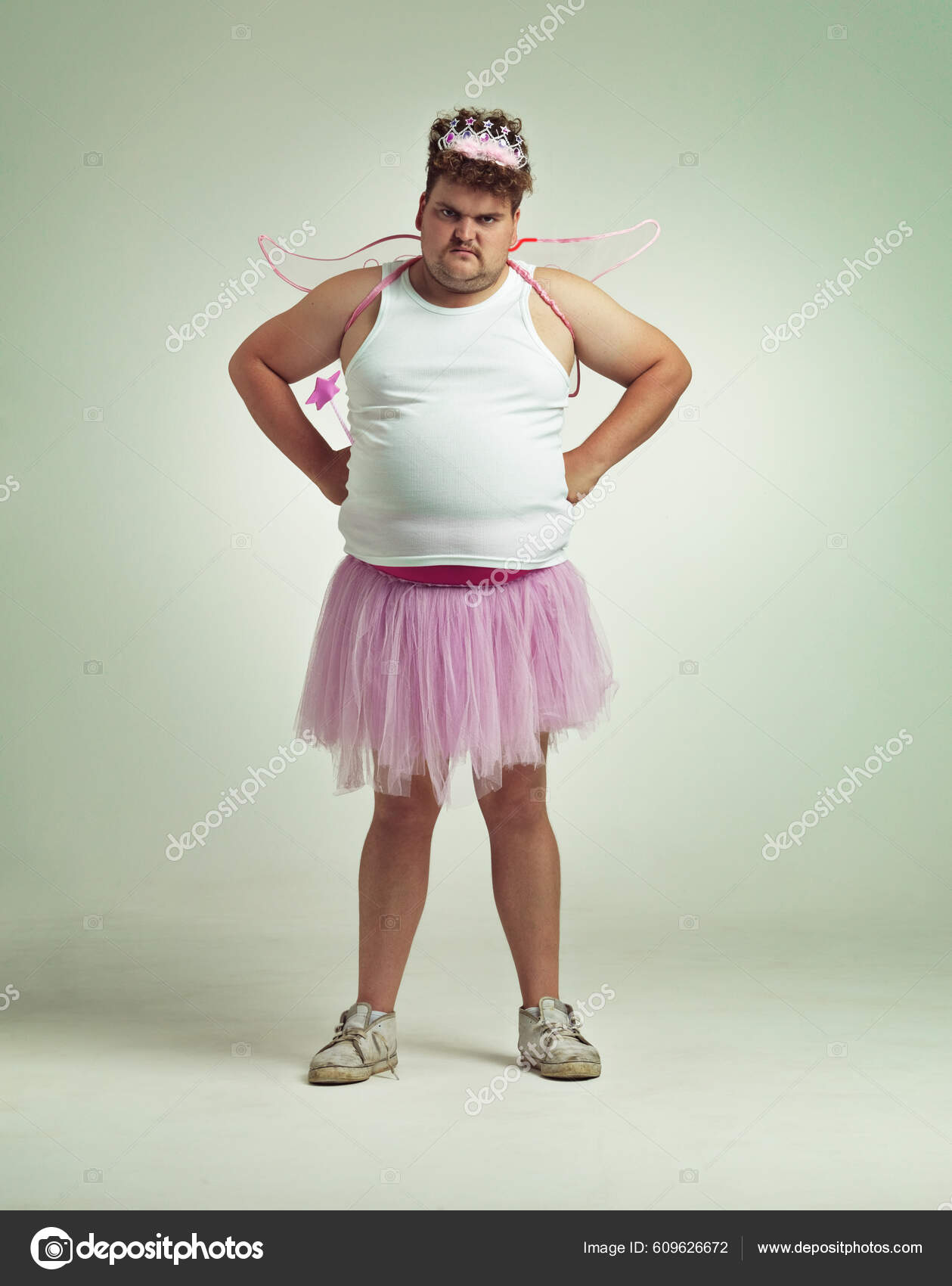 A person taking a selfie of themselves in a bizarre outfit, holding their phone up with a confident expression.