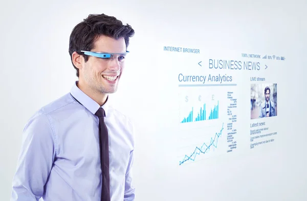 One way to see into the future. Studio shot of a young businessman against a white background using smart glasses to check the weather forecast