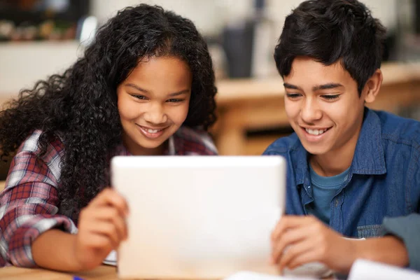 Learning in the digital classroom. two young teenagers using a digital tablet together