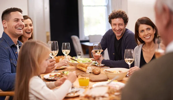 Friends and family are the true gifts in life. a family sitting down to dinner