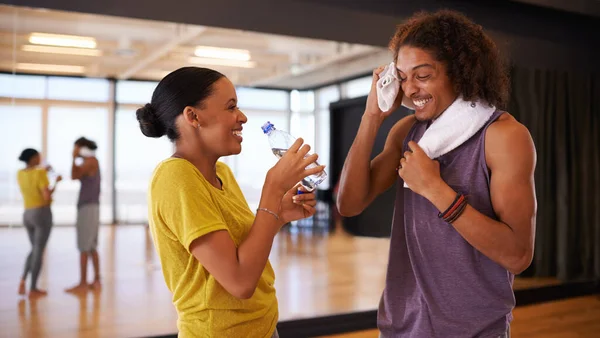 Working together towards a perfect performance. two young people practicing in a dance studio