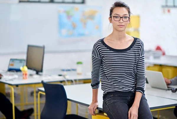 Starting up a business isnt easy, but its worth it. Serious young woman posing in a modern open plan office space