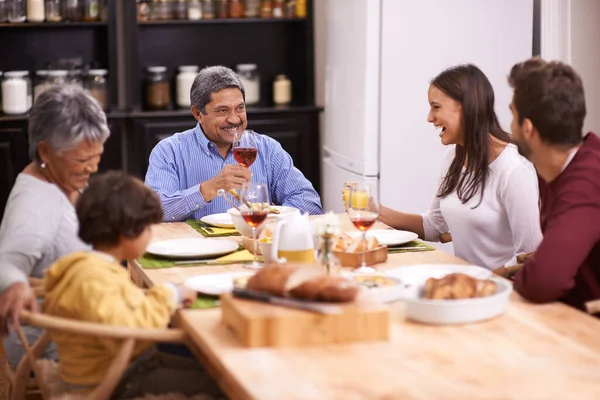 Cheers to the best family. A shot of a happy family sharing a meal together