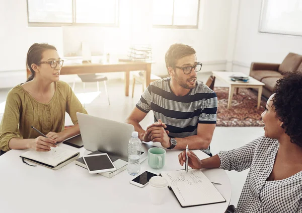 This team works hard for success. a group of coworkers having a meeting in an office