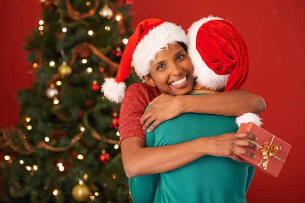 そうすべきではなかった クリスマスプレゼントをもらった若い女性が友達を抱きかかえて — ストック写真