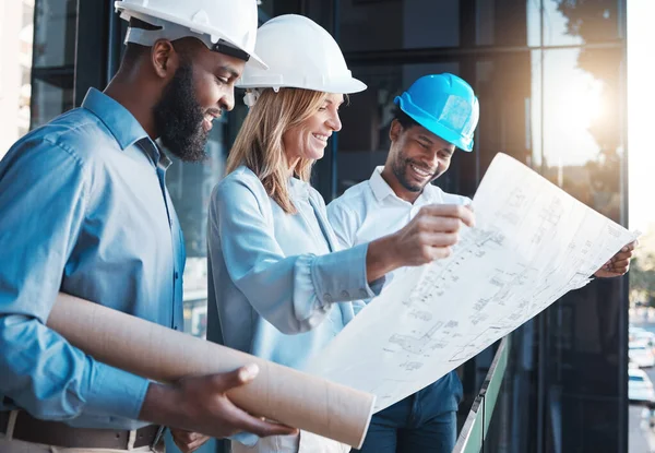 Architecture, construction building with an architect, engineer and designer working as a team and reading a blueprint. Teamwork, collaboration and development with a group of creative staff.