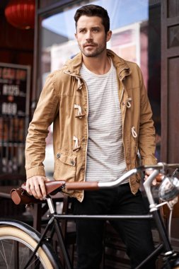 Time for a cycle. a fashionable young man holding a bicycle clipart