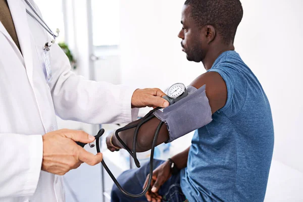 Feeling under pressure. a doctor taking a male patients blood pressure