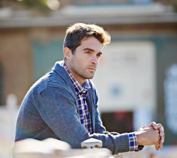 What does it all mean. a handsome young man leaning over a railing