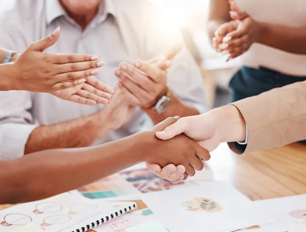 Business people handshake for promotion, celebration or b2b contract deal with group or team applause in office meeting. Diversity project women shaking hands for teamwork, commitment and onboarding.