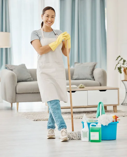 Cleaning floor, house work and woman working in home service mopping living room, doing job with smile and happy to clean house apartment. Portrait of Asian cleaner or housewife housekeeping.