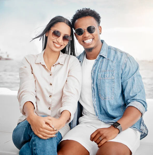 Sunglasses, summer and couple portrait at the beach for holiday, vacation with casual fashion style. Gen z or millennial woman, man or people smile together with ocean, sea and clear sky mock up.