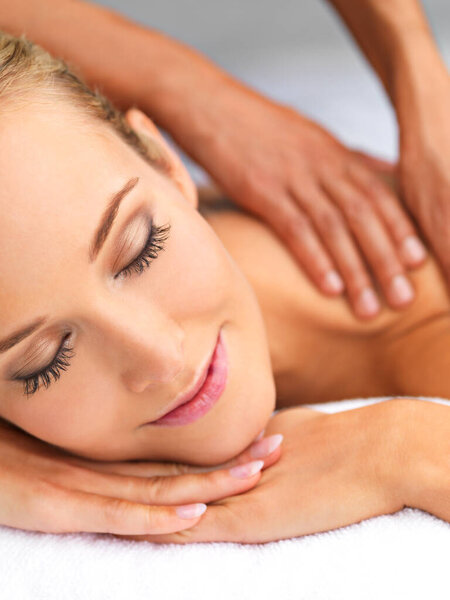 Indulging in some blissful me time. A beautiful young woman relaxing in a spa - massage therapy