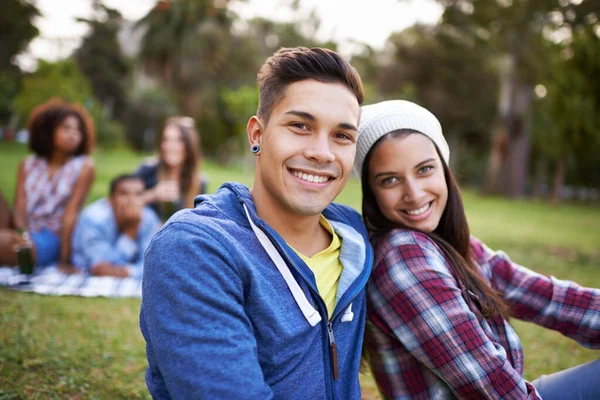 就在公园里一对快乐的年轻夫妇在公园里与朋友在一起的肖像 — 图库照片