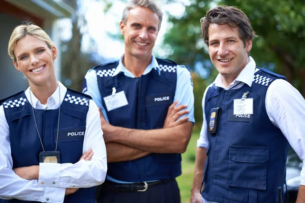 Your friendly local force. three smiling members of the police force