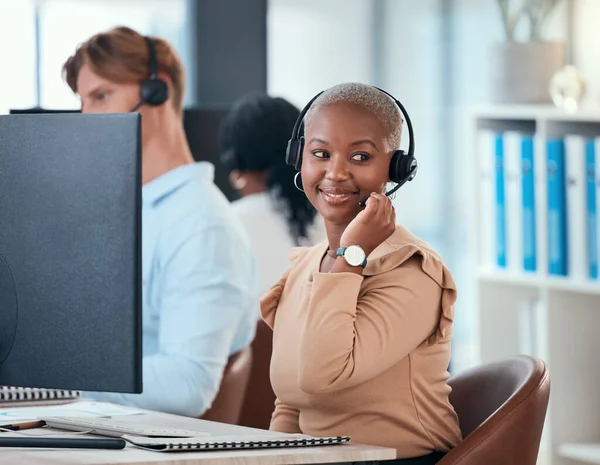 Black woman working in call center, customer service or online help desk office on conversation with client or customer. Communication, consulting and telemarketing consultant giving a sales pitch.