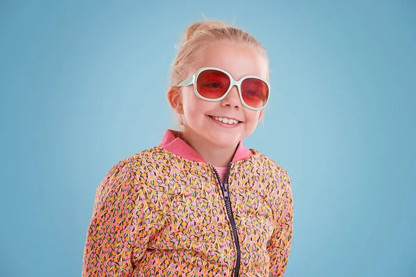 我想这真的是我 工作室拍摄的一个穿着蓝色背景的时髦眼镜的小女孩 — 图库照片