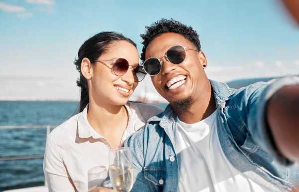 Couple selfie on yacht in ocean celebrate with champagne on vacation or holiday in summer. Happy young man with luxury wine, cruise at sea with woman for celebration or honeymoon travel on ship.