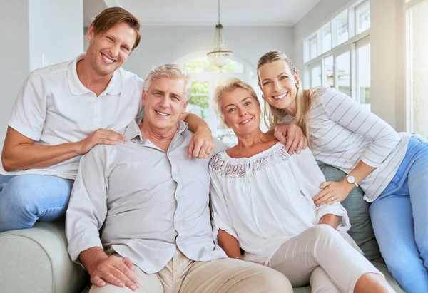 Family portrait in living room or parents house with women, men and happy senior retirement couple. Happiness, love and care for grandparents in summer holiday house with lens flare for mental health.