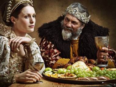 Hes feasting and his goblet is full...again. A bored queen sitting alongside her husband at a banquet clipart
