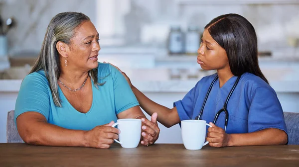 Black woman, nurse or elderly patient support, talking or comfort. Medical consultant, caregiver or female doctor having conversation with elderly woman at nursing home for trust, advice or help