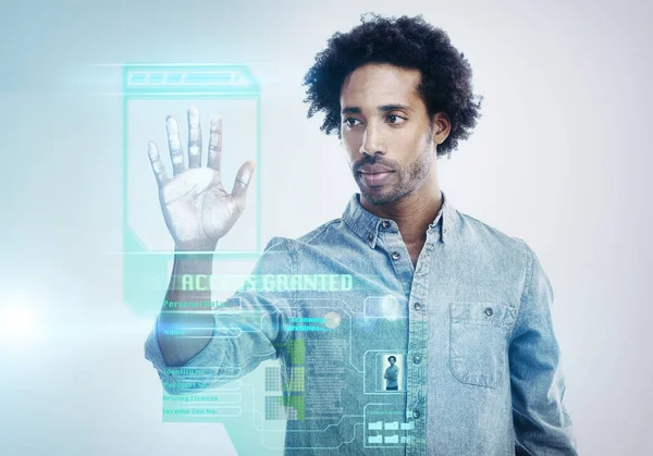 Privacy is priority. A handsome young black man using a transparent touchscreen