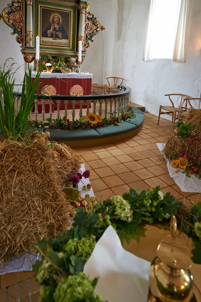 Offerings for the harvest festival. Offerings decorating an altar in a church during the harvest festival