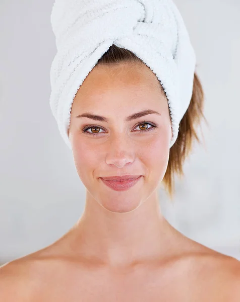 What shall we do first Hair. Head shot of a stunning brunette woman with her hair wrapped up in a towel