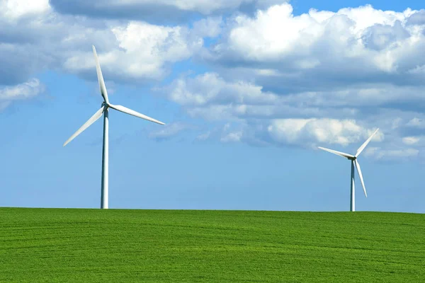 Creating energy with the wind. wind turbines on a grassy field