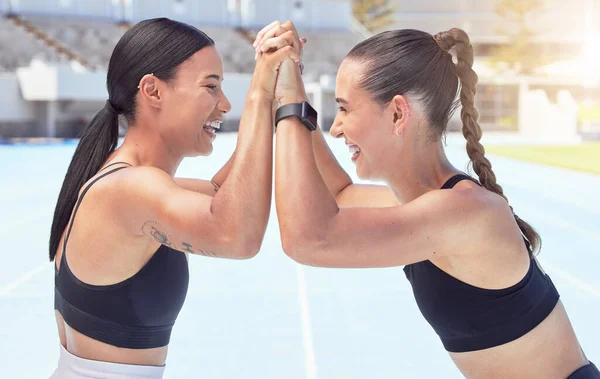 Motivation, energy and high five by women exercise and sport success on a track with hands in support of a victory. Happy, teamwork and goal achievement by friends celebrating body progress together.