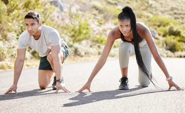 Sports race, fitness couple and ready to run asphalt road with competitive, fit and active runners for outdoor workout. Asian man and black woman sitting in position to start sprint, athlete training.