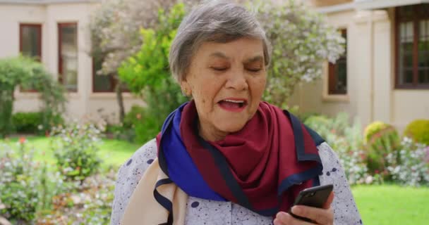 老年妇女 电话和社交媒体在大自然的老人院外面笑的时候开玩笑说 老年人上网 享受与他人的交流和5G网络的乐趣 — 图库视频影像