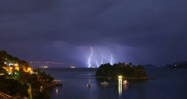 Stormy night over the island. a dramatic thunderstorm over sea and land