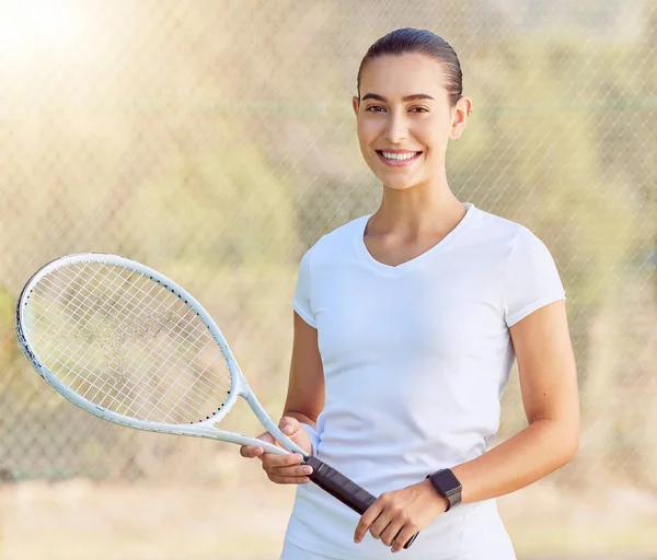Woman, tennis and sports motivation on a court for fitness game, workout and competition training. Portrait, smile and happy player with racket for energy exercise, health wellness and winner mindset.