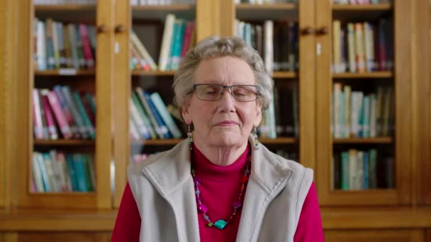 Portrait Senior Woman Sitting Library Read Books Novel Literature Bookshelf — Stock Video