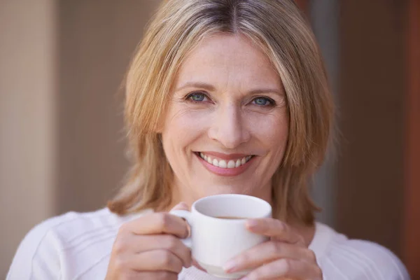 The pleasure of a cup of tea. Closeup portrait mature woman enjoying a cup of tea