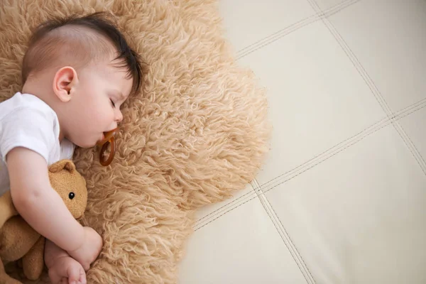 He always naps after feeding. an adorable baby boy taking a nap