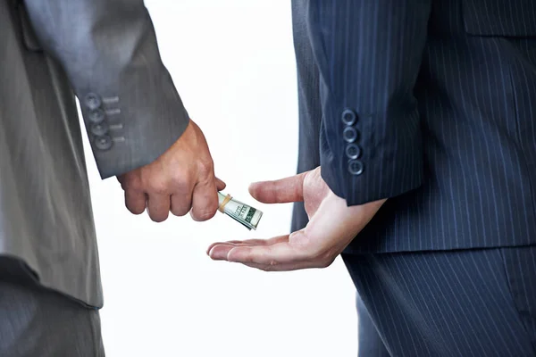 Sneaky Deals Cropped Studio Shot Money Passing Two Businessmens Hands — Stock fotografie