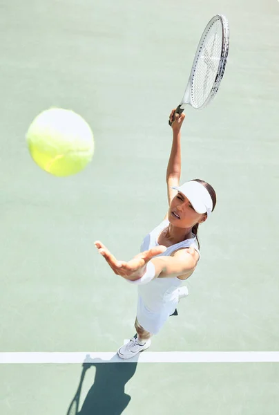 Top view, tennis court and woman serving ball in training competition, game and professional summer match. Sports athlete with motivation or vision in workout, exercise or fitness with winner mindset.