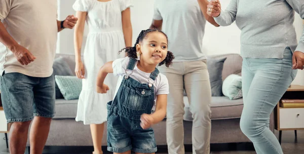 Happy girl with family dancing in living room while playing, having fun and enjoy bonding quality time together. Happy family love, connection and freedom for youth child or kid at home dance party.