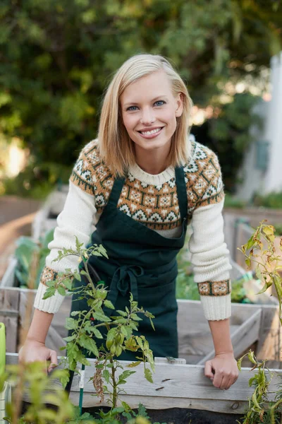 Gardening is my passion. A beautiful young woman gardening outside