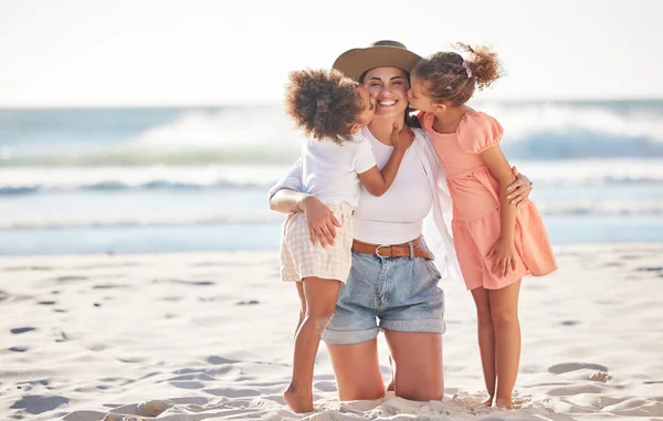 Mom, kiss or children bonding on beach in Portugal in trust, security or love hug. Smile, happy or support parent with girls, kids or family on relax holiday, mothers day or summer break by ocean sea.